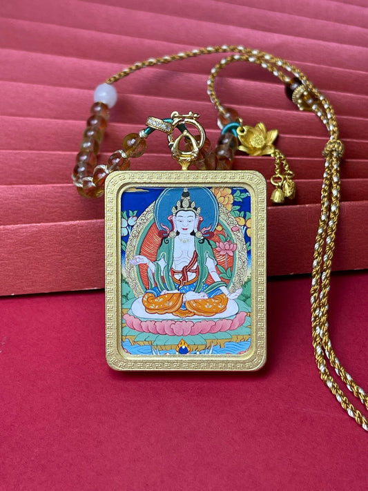Close-up of Mahasthamaprapta Bodhisattva thangka pendant showing detailed mineral pigment painting, copper protective frame, and yellow crystal handwoven necklace cord