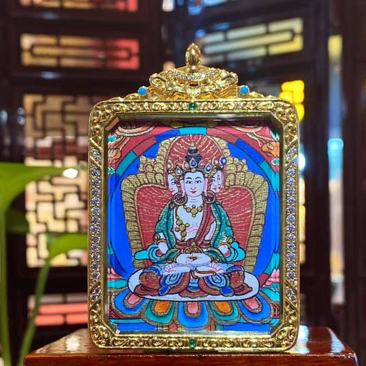 Front view of a double-sided hand-painted Vairocana Buddha mini thangka pendant set in a gold-plated copper Gawu box, 55×45mm