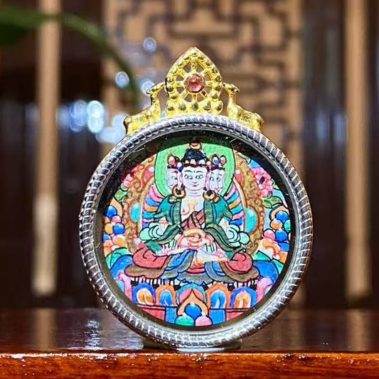 Hand-painted Vairocana Buddha round mini thangka pendant in an S925 sterling silver Gawu box, front view showing the Great Sun Buddha, 24mm
