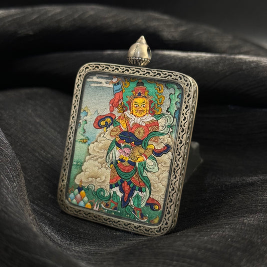Front view of Vaishravana Northern Guardian King mini thangka pendant hand-painted with mineral pigments in a 925 silver Nine-Colored Deer relief case