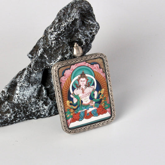 Full view of Vajrasattva mini thangka pendant showing compact portable format, traditional Tibetan painting composition, mineral pigment colors, and the solid silver protective case with top bail