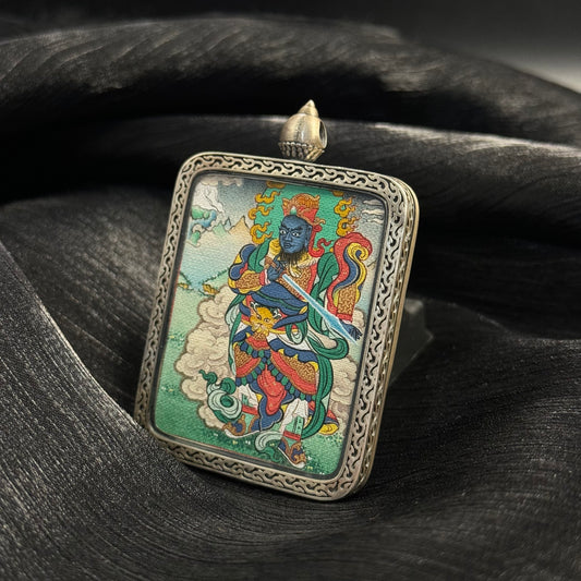 Angled view of Virudhaka Southern Guardian King mini thangka pendant showing hand-painted Tibetan thangka inside 925 silver pendant frame