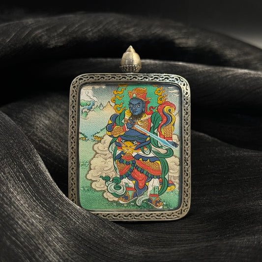 Front view of Virudhaka Southern Guardian King mini thangka pendant hand-painted with mineral pigments in a 925 silver Nine-Colored Deer relief case