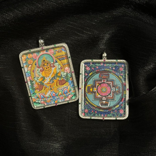 Front and back view of a Yellow Jambhala mini thangka pendant showing the hand-painted Tibetan wealth deity and a detailed mandala design on the reverse side within a decorative pendant frame.