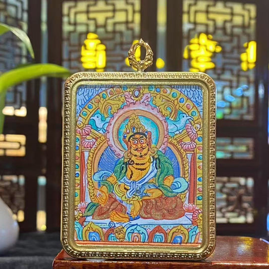 Front view of hand-painted Yellow Jambhala Thangka set in a titanium steel Tibetan Gawu pendant, wealth and protection amulet