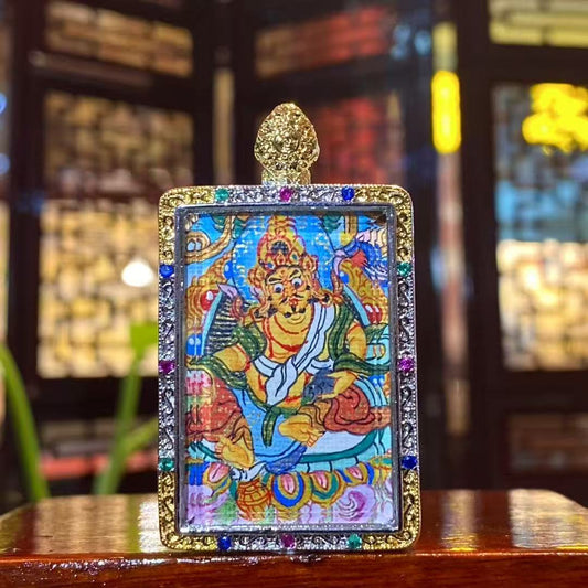 Front view of hand-painted Yellow Jambhala Thangka inside a gold-plated Tibetan Gawu pendant, God of Wealth amulet