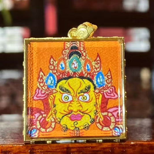 Hand-painted Yellow Jambhala mini Thangka pendant in an 18K gold Gau box with sapphire crystal glass