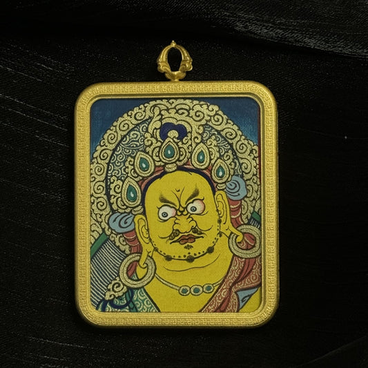 Front view of Yellow Jambhala mini thangka pendant featuring hand-painted wealth deity portrait in Rebgong thangka style mounted in a copper pendant frame