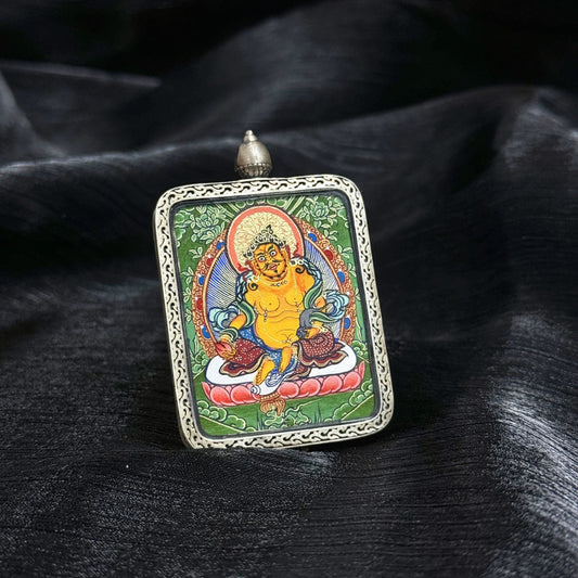 Front display of Yellow Jambhala Rebgong mini thangka pendant showing vivid mineral pigment painting and protective 925 silver pendant casing