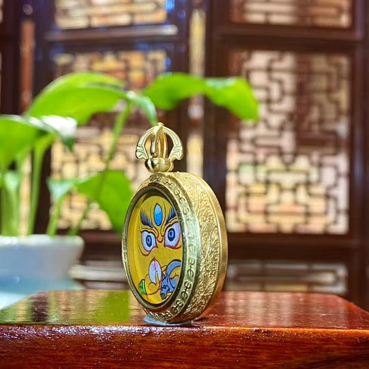 Side view of Tibetan Yellow Jambhala Gawu pendant showing titanium steel construction and balanced thickness