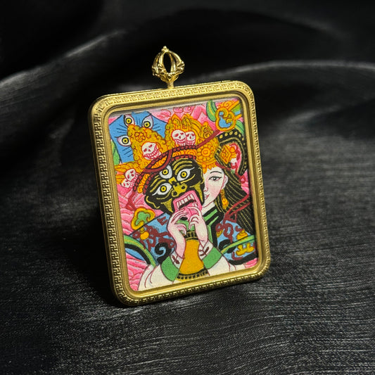 Close-up view of Zaki Lhamo hand-painted mini thangka pendant highlighting detailed facial expression, vibrant mineral pigment colors, and miniature thangka painting craftsmanship.