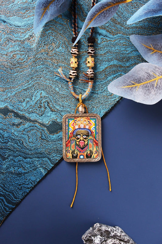 Zaki Lhamo Tibetan wealth deity thangka pendant featuring vivid colors, raised gold powder detailing, and a traditional Rebgong hand-painted style, symbolizing powerful wealth attraction and protection