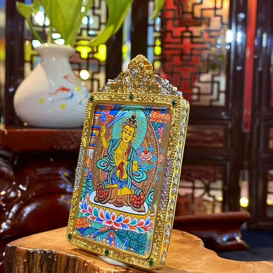 Side view of a Manjushri Bodhisattva mini thangka pendant highlighting the ornate gold-plated copper Gau box frame
