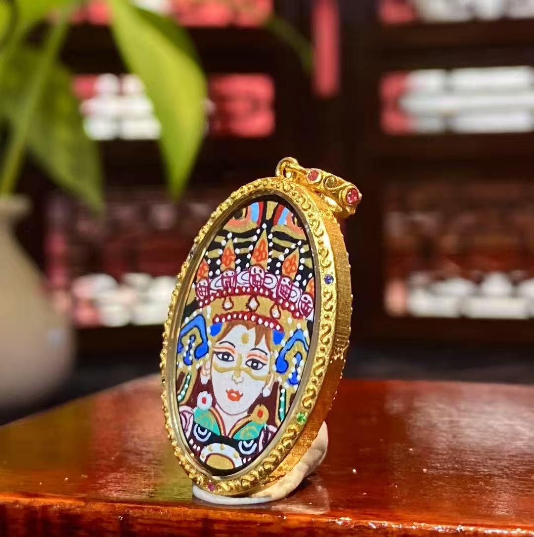Side view of an 18K gold Tibetan Ghau Thangka pendant showing handcrafted Ghau case and sapphire crystal glass
