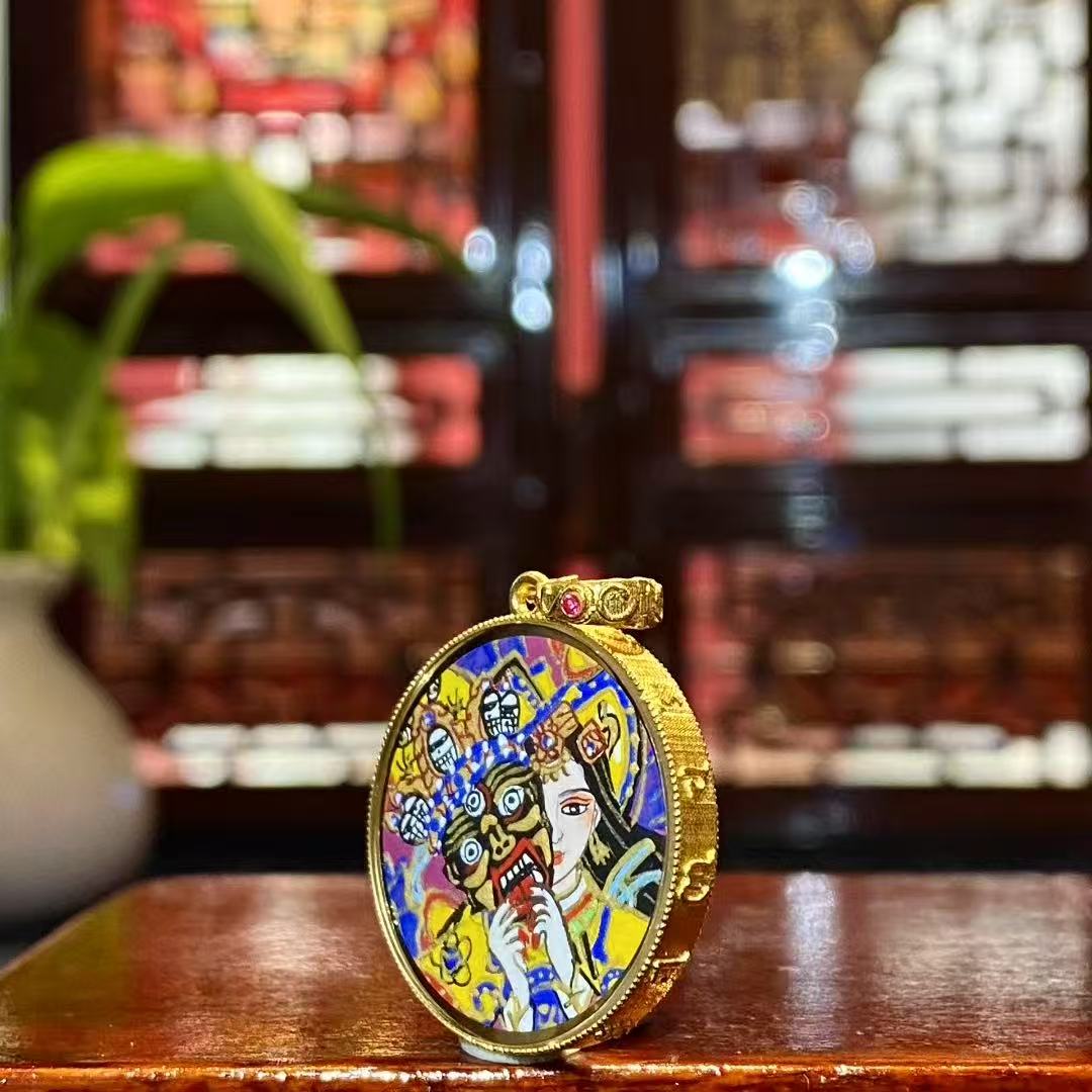 Side view of an 18K gold Tibetan Ghau Thangka pendant showing handcrafted Ghau case and sapphire crystal glass