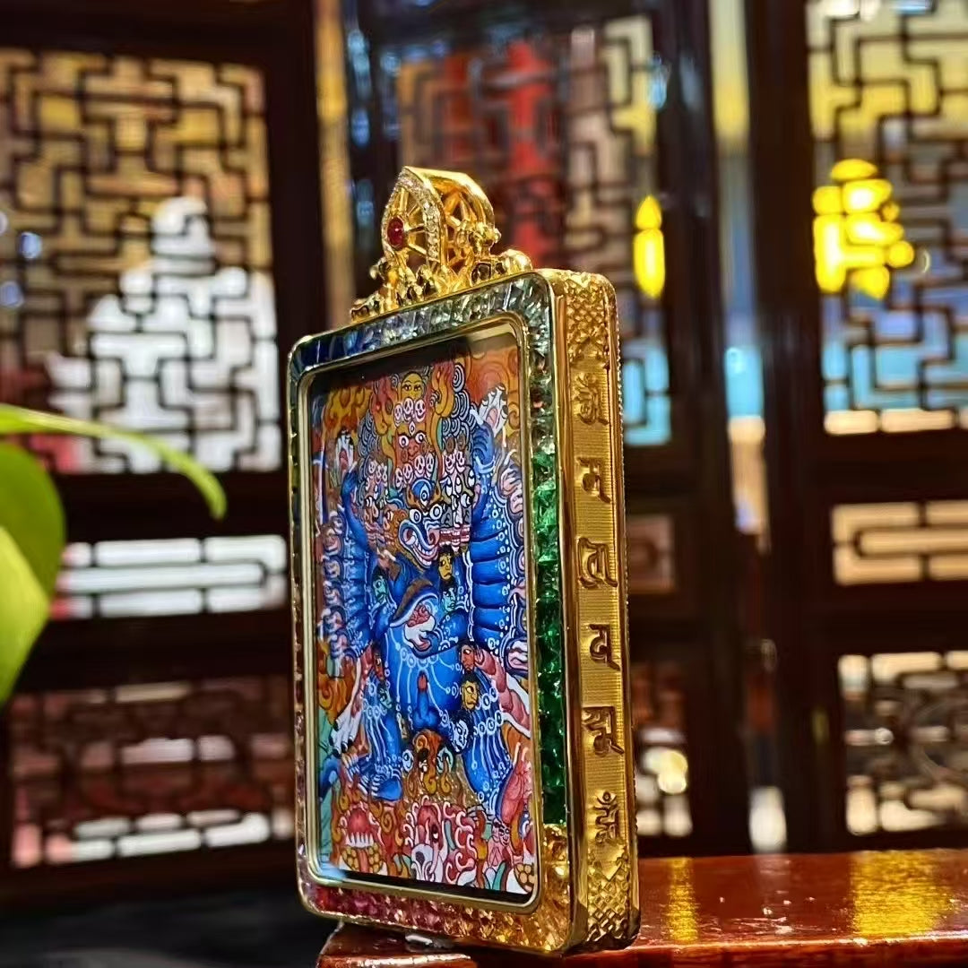 Side view of 18K gold Gau box thangka pendant showing sapphire crystal protection and rainbow gemstone inlay craftsmanship