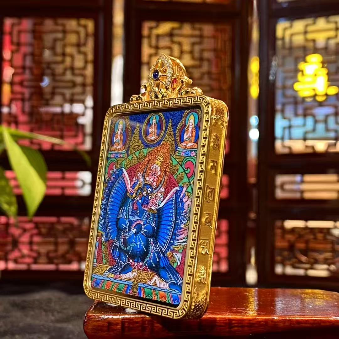 Side view of 18K gold Gau box thangka pendant showing sapphire crystal protection and twin deer Dharma clasp design