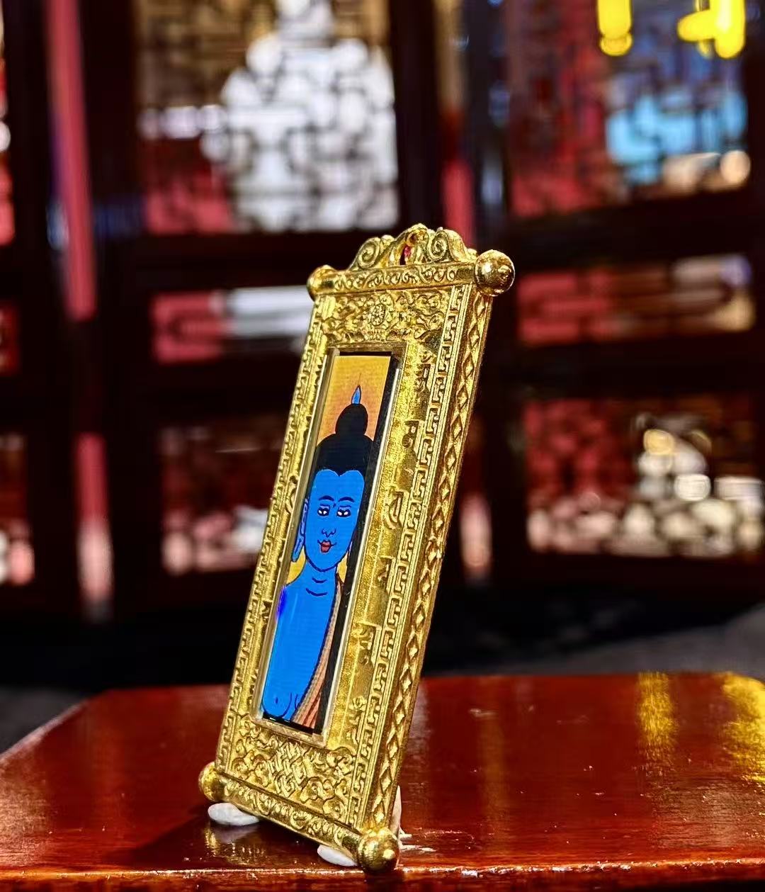 Side view of 18K gold gau box Tibetan scroll thangka pendant with sapphire crystal lens and hand-painted artwork