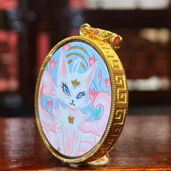 Side view of 18K gold gau box Tibetan thangka pendant featuring Fox Spirit artwork, sapphire crystal lens and hand-painted Rebgong craftsmanship