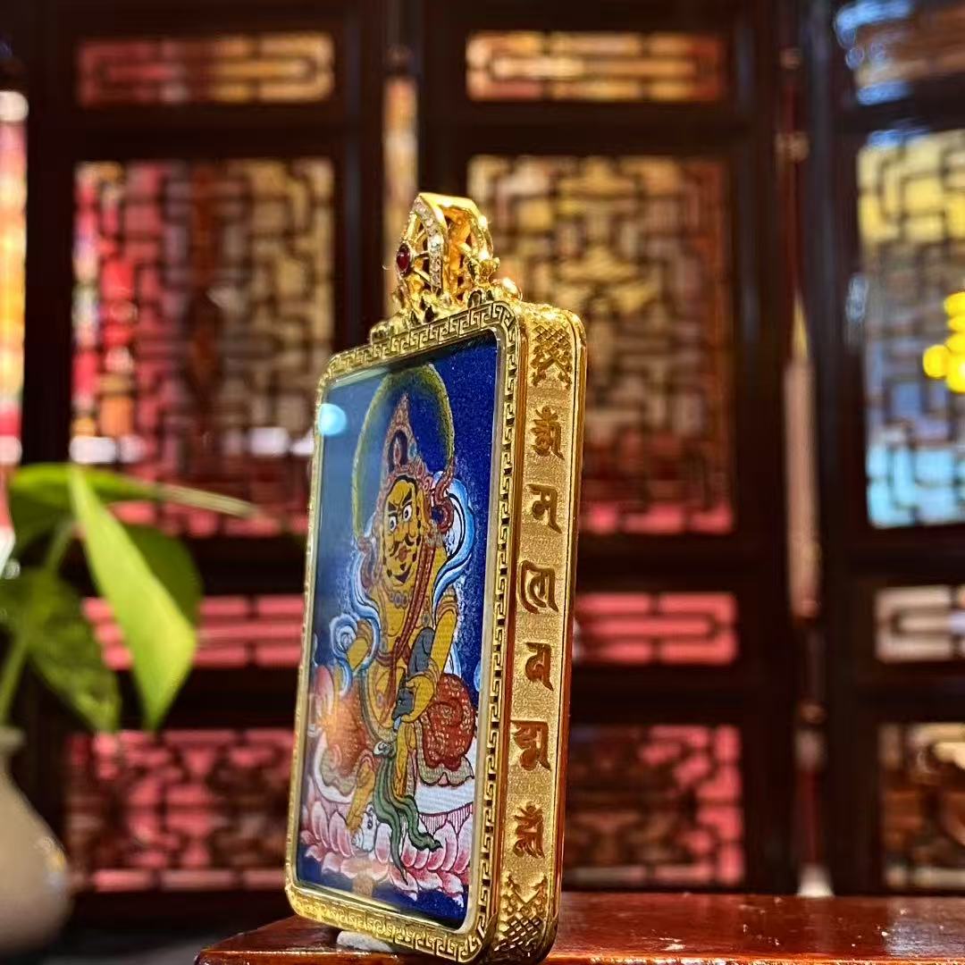Detail of 18K gold Gau box with sapphire crystal mirror, showcasing craftsmanship of a double-sided Tibetan Gau Thangka pendant