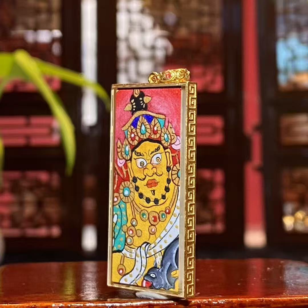 Side detail of elongated 18K gold Gau box with sapphire crystal mirror, showing craftsmanship of a Rebgong hand-painted double-sided Gau Thangka pendant