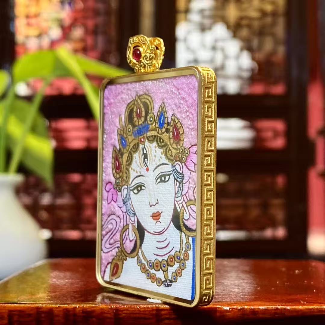 Side view of an 18K gold Tibetan Ghau Thangka pendant showing handcrafted case structure and sapphire crystal glass