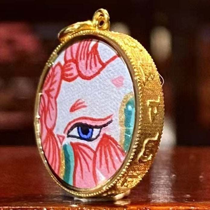 Side view of 18K gold Tibetan thangka charm showing small hanging loop, suitable for bracelet or necklace customization