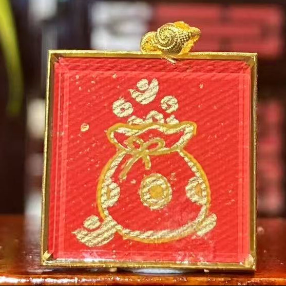 Back view of double-sided Tibetan mini thangka pendant featuring hand-painted wealth pouch symbol in 18K gold, Rebgong craftsmanship