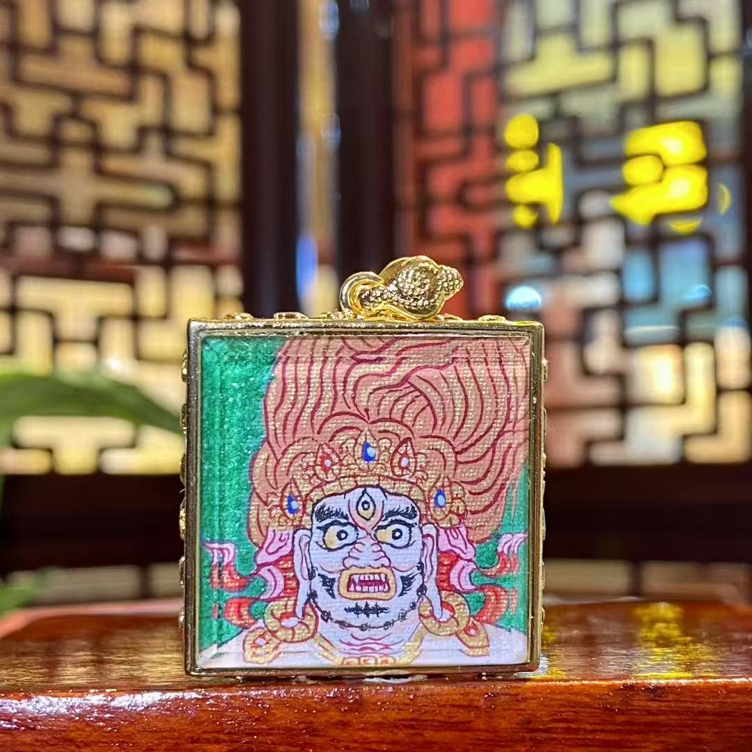 Hand-painted Acala Vidyaraja Thangka Gau Pendant in gold-plated copper, featuring a fierce and protective depiction of the Wisdom King.