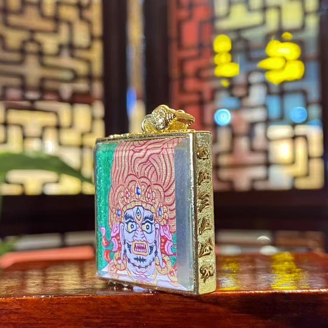 Side view of the Acala Vidyaraja Thangka Gau Pendant, showcasing the gold-plated copper casing and detailed craftsmanship.