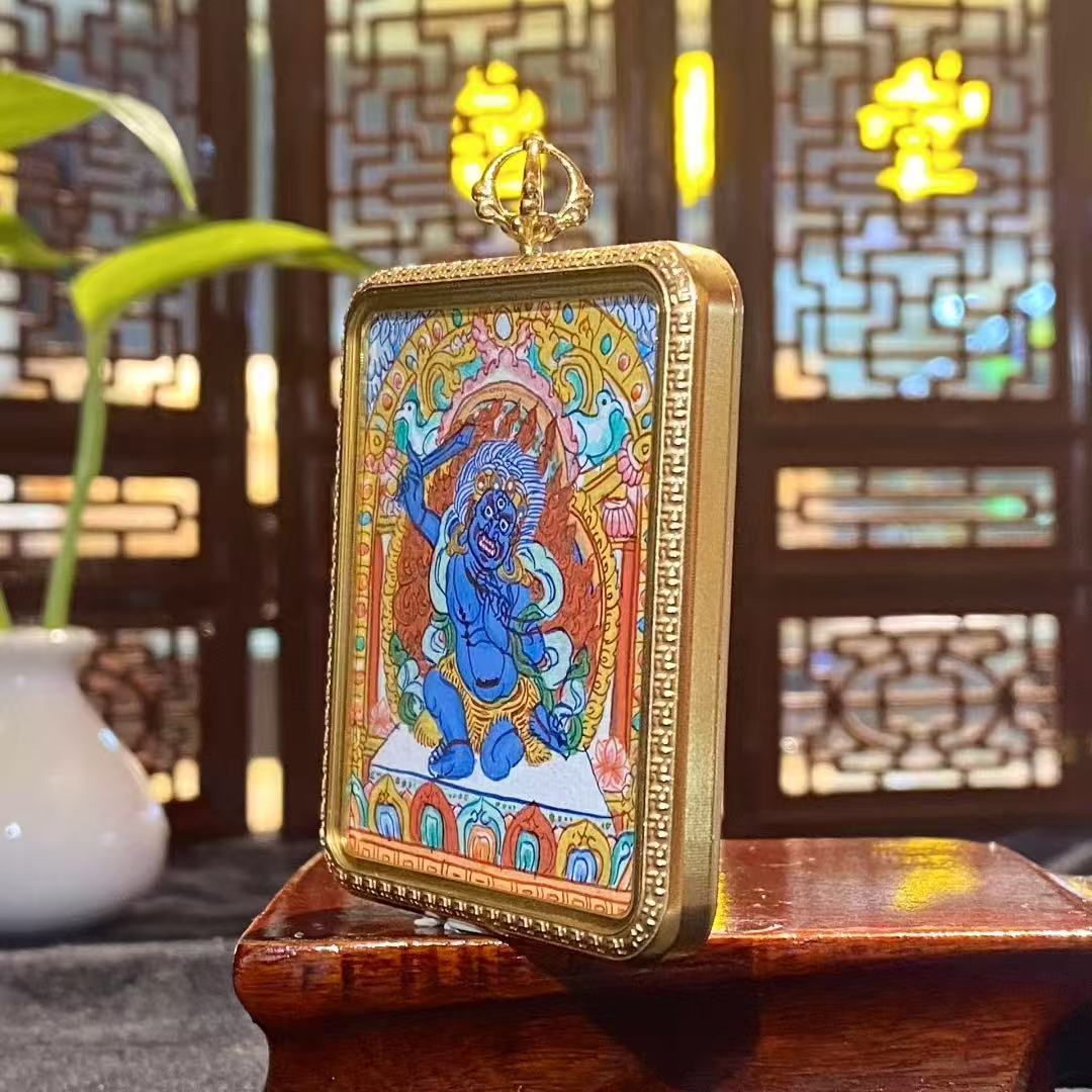 Side view of the Acala Vidyaraja Thangka Gau Pendant, showcasing the titanium steel structure and detailed artwork.