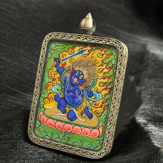 Close-up of Acala Vidyaraja Thangka showing the intricate details of gold accents and mineral pigments used in this Rebgong Tradition painting, mini size (3.5 × 4.5 cm).