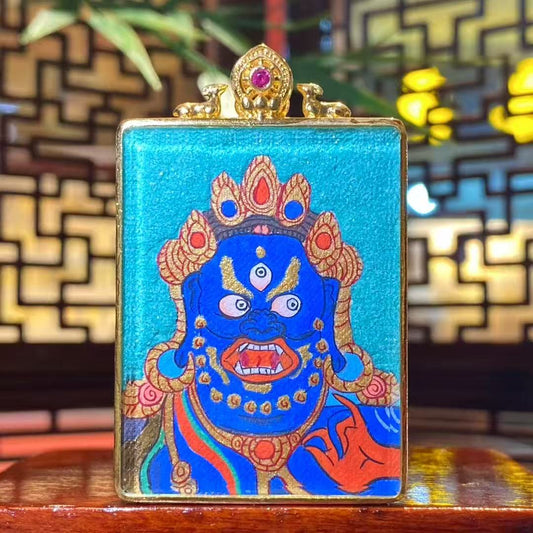 Hand-painted wrathful face of Acala Vidyaraja in deep blue, depicted as a close-up protective amulet on a Tibetan Gawu pendant designed for immediate guardianship
