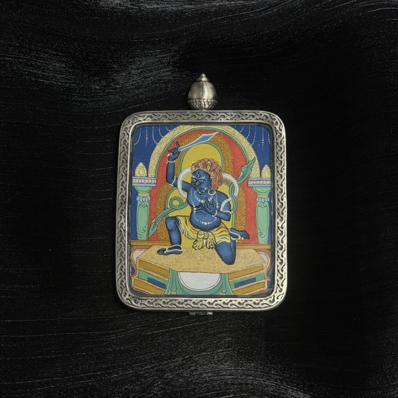 Front view of Acalanatha (Fudo Myo-o) mini Thangka pendant hand-painted with mineral pigments and set in a Dunhuang Nine-Color Deer silver case