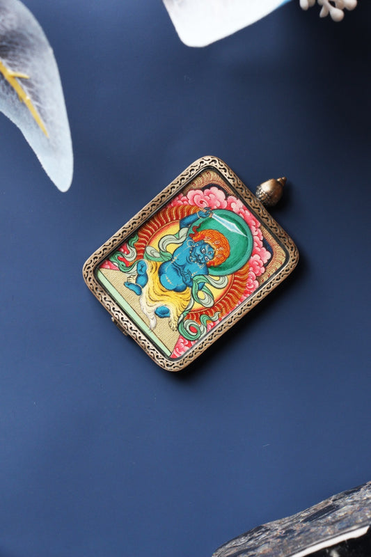 Front view of Acalanatha (Fudo Myo-o) mini thangka pendant, hand-painted with mineral pigments, set in a Tibetan silver gawu-style case