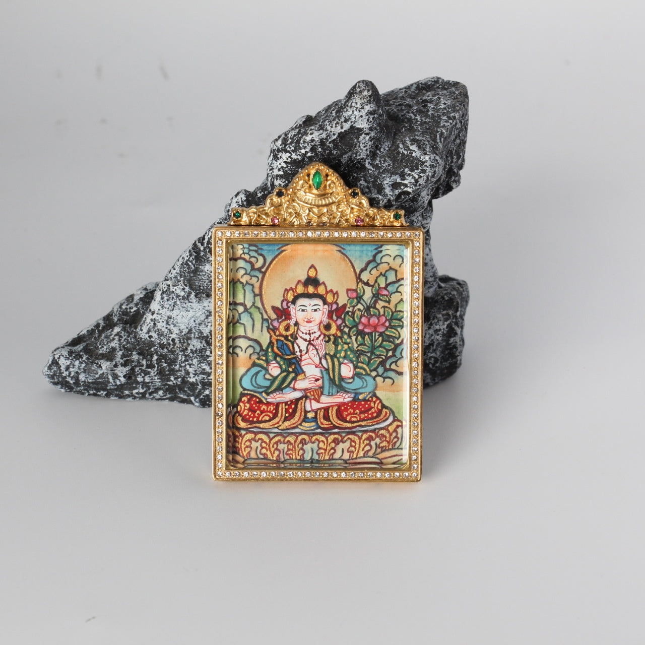 Front view of an Akashagarbha Bodhisattva mini Thangka pendant, featuring a light-toned Nepal-style painting framed in a gold-tone, jewel-embellished titanium steel case.