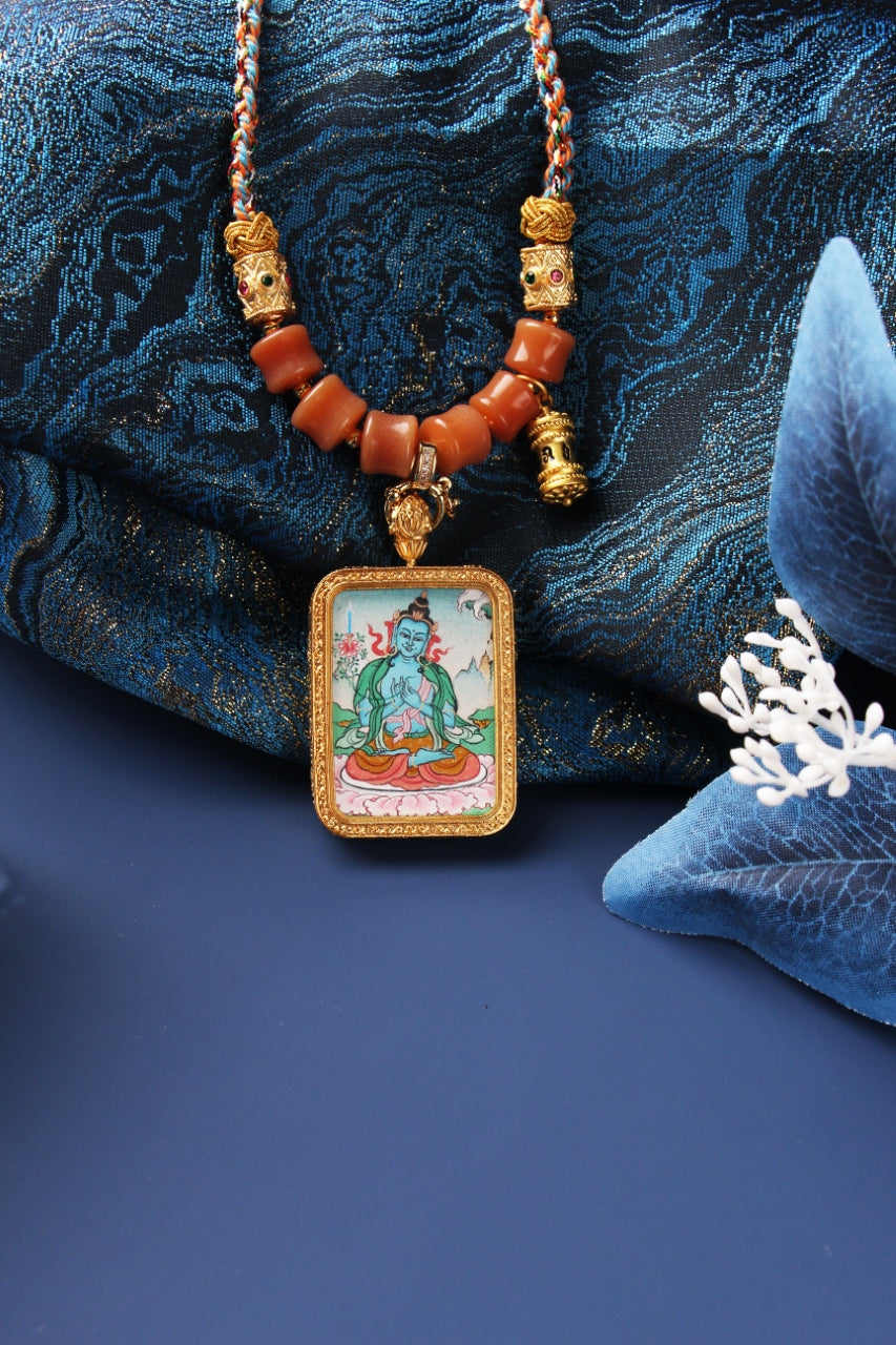Front view of Akashagarbha Bodhisattva mini thangka pendant highlighting the hand-painted figure, cloud base details, textured rectangular bezel, and symmetrical bead arrangement