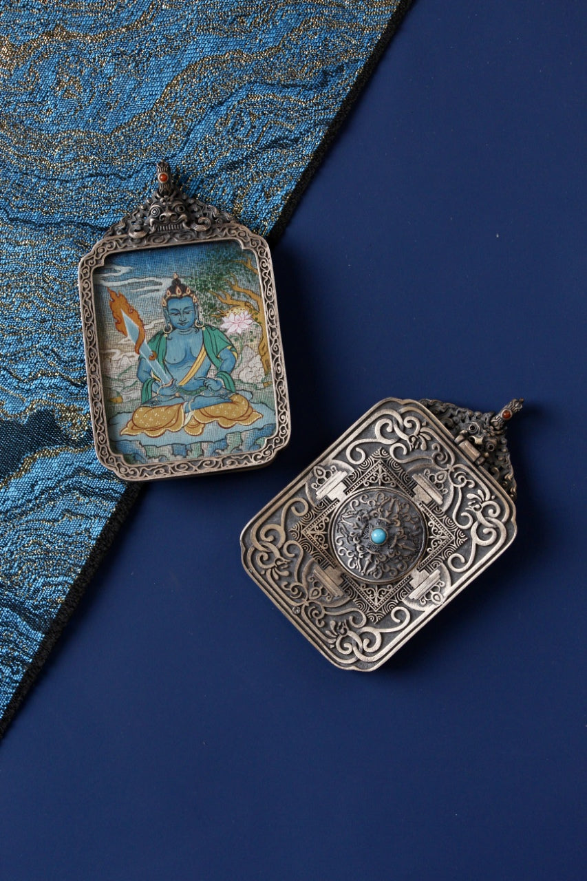 Front and back view of Akashagarbha Bodhisattva mini thangka pendant, hand-painted with mineral pigments and set in a vintage silver case, Tibetan origin