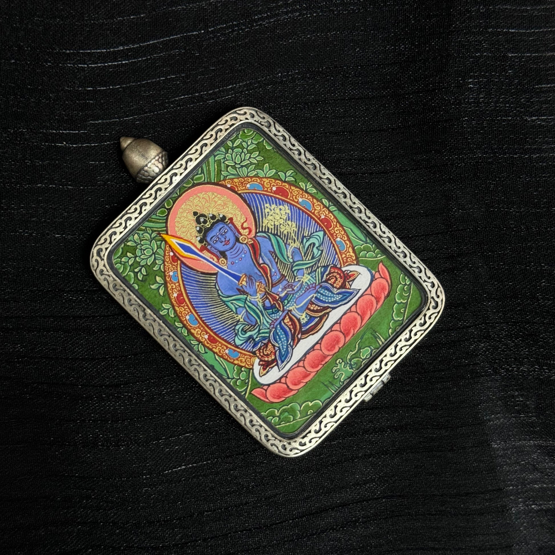 Top perspective of Akashagarbha Bodhisattva thangka pendant displaying the full hand-painted composition, lotus seat, bodhisattva figure and decorative silver frame