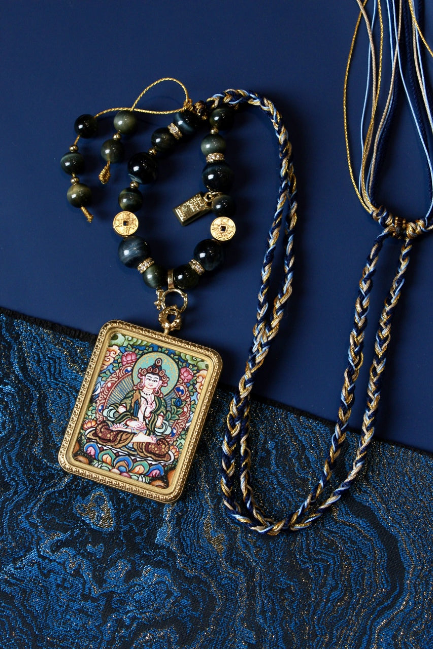 Full view of Akashagarbha mini thangka pendant necklace with braided cord and bead details
