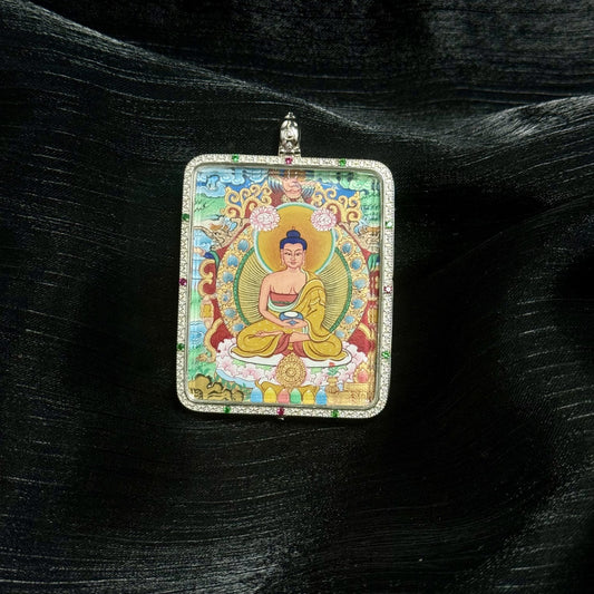 Front view of a hand-painted Amitabha Buddha mini thangka pendant set in a double-sided silver gawu case, featuring mineral pigment detailing, symmetrical Tibetan composition, and decorative gemstone inlaid frame.