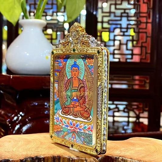 Side view of Amitabha Buddha Gau pendant highlighting the gold-plated copper frame, gemstone accents, and ornate handcrafted metalwork