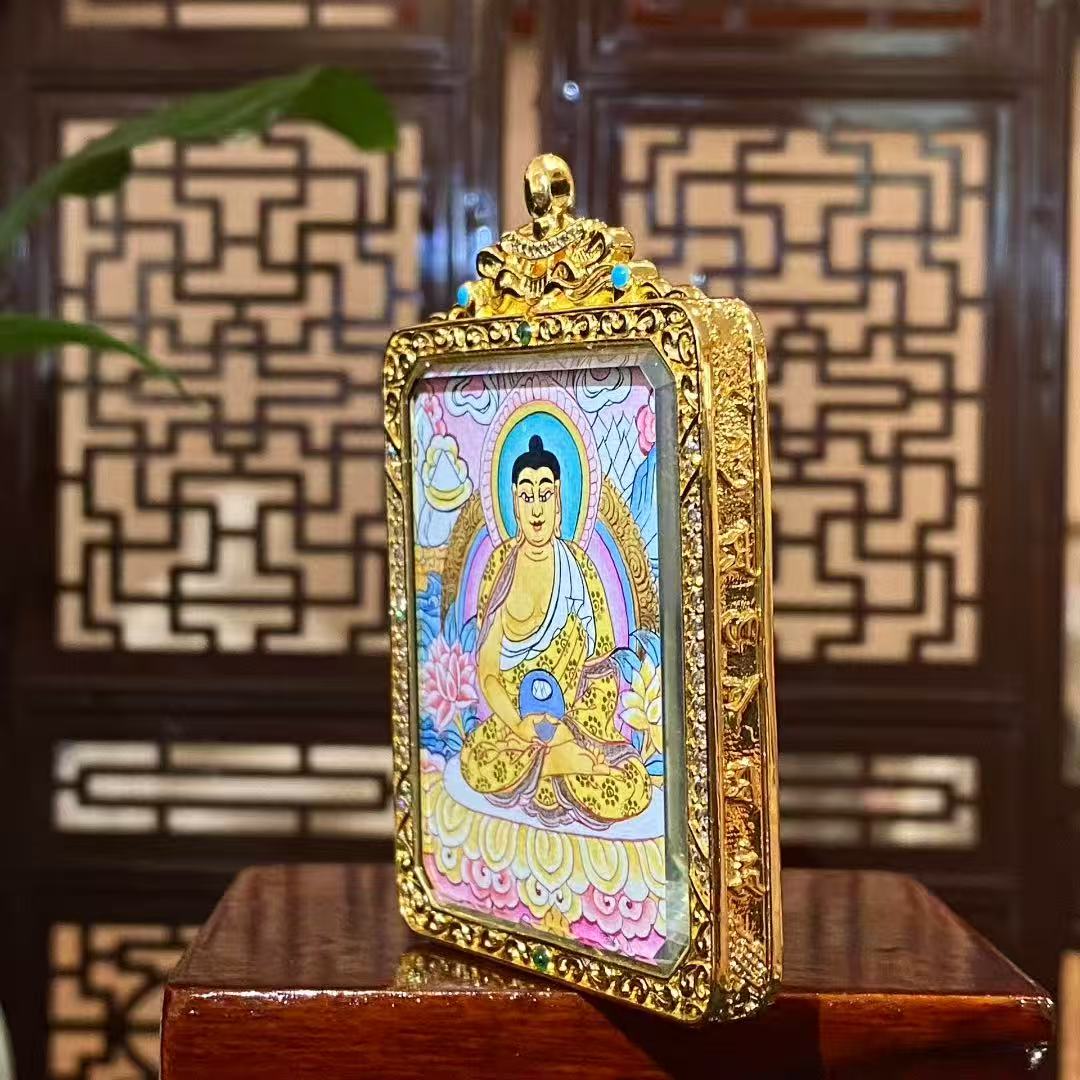 Side view of Amitabha Buddha Gau pendant highlighting the gold-plated copper frame, gemstone accents, and fine craftsmanship details