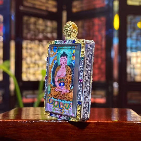 Side view of Amitabha Buddha mini thangka Gau pendant showing the gold-plated copper frame, vertical rectangular format, and fine handcrafted details