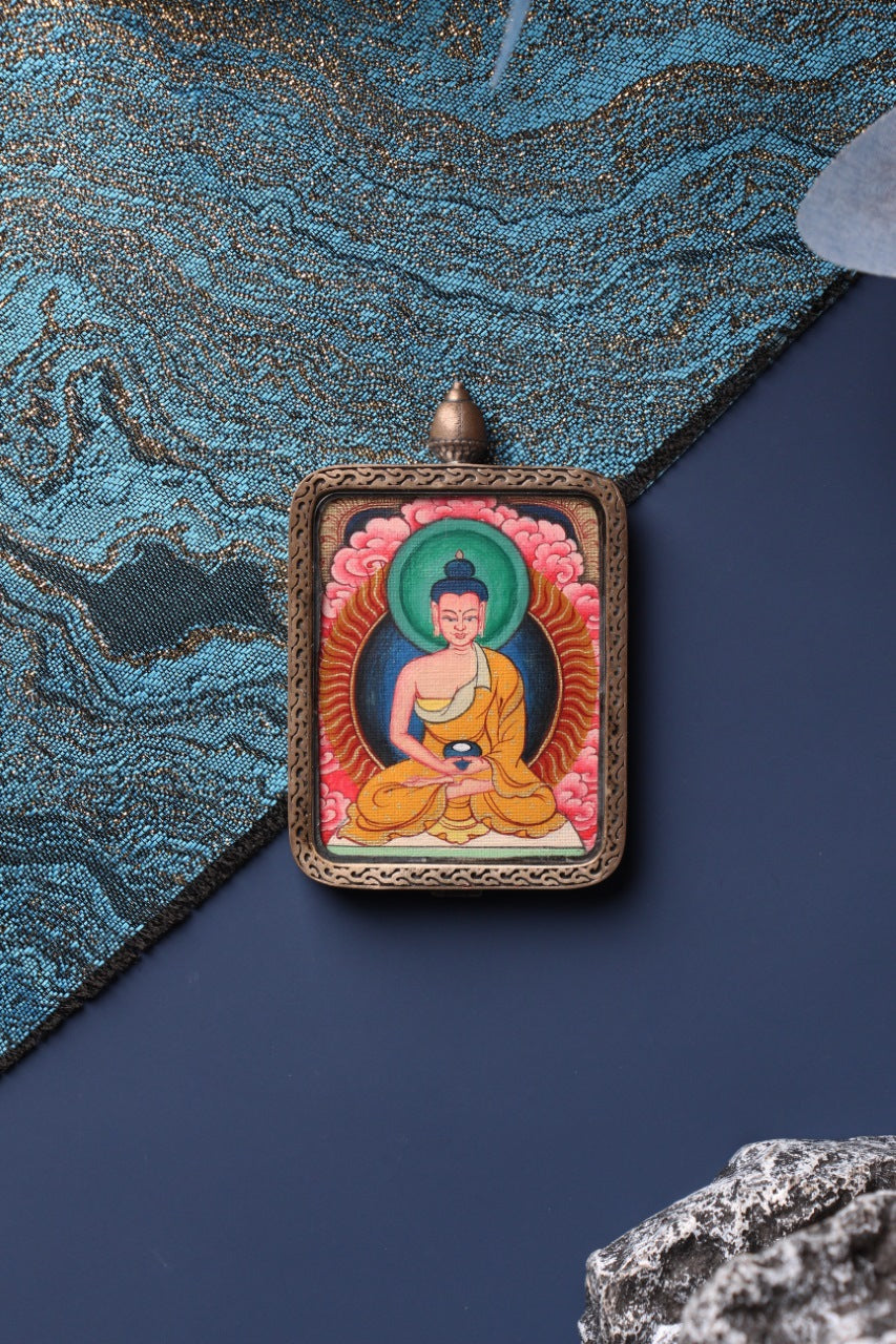 Front view of the Amitabha Buddha mini thangka pendant in Zangka format, a compact Tibetan devotional artwork hand-painted with mineral pigments and protected by a sterling silver case, suitable for travel devotion and personal shrine display.