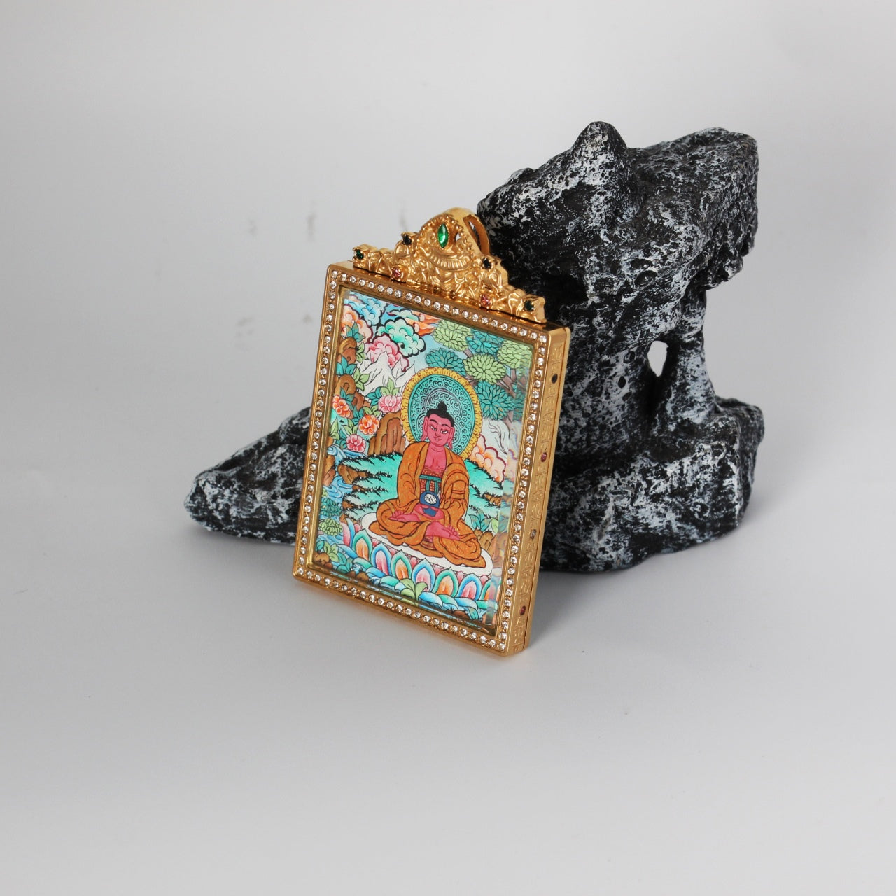 Side detail of Amitabha Buddha mini thangka pendant highlighting double-sided construction, metal edge finishing, and crystal-style border detailing around the frame