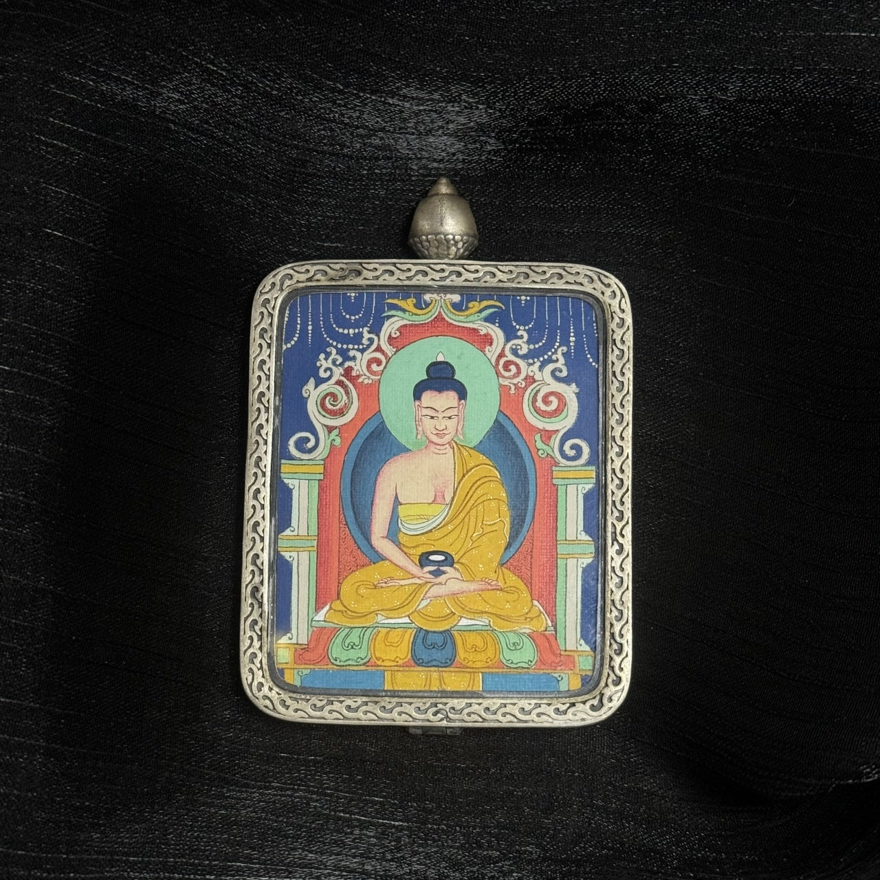 Front view of Amitabha Buddha mini Thangka pendant, hand-painted with mineral pigments and set in Dunhuang Nine-Color Deer silver case
