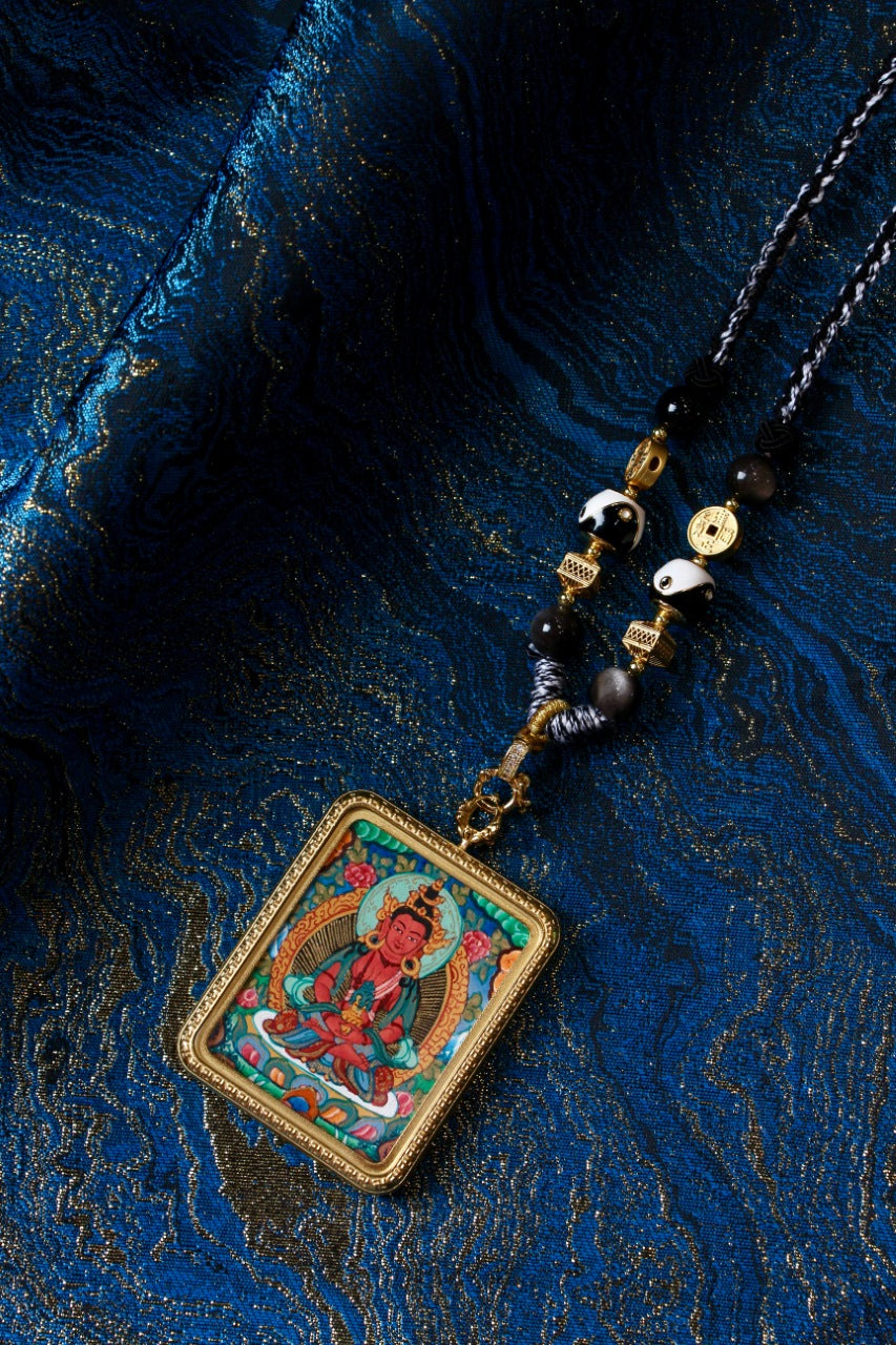 Angled view of Amitayus Buddha Nepalese Color Thangka pendant, finely hand-painted with mineral pigments and framed in titanium steel