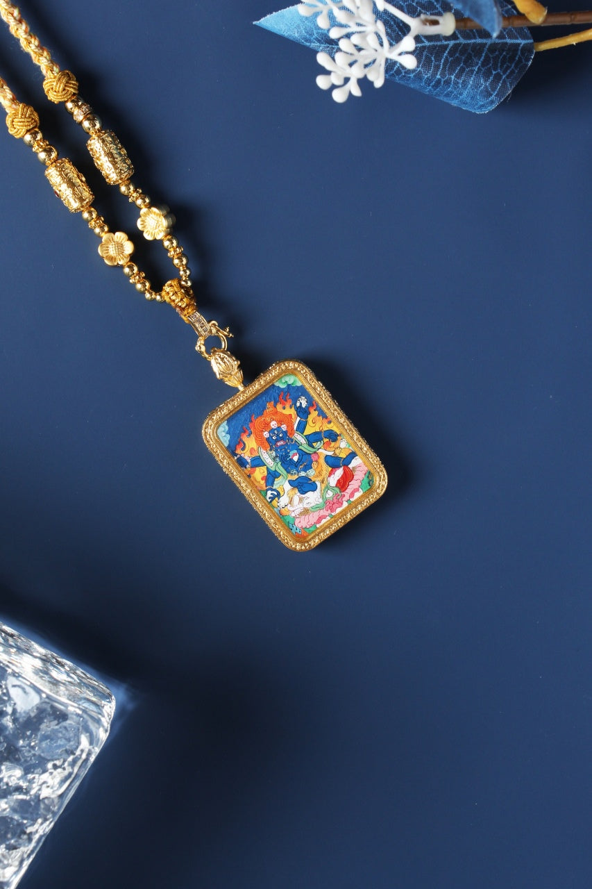 Angled front view of Six-Armed Mahakala pendant showing detailed iconography and gold-toned frame, portable Tibetan mini thangka format