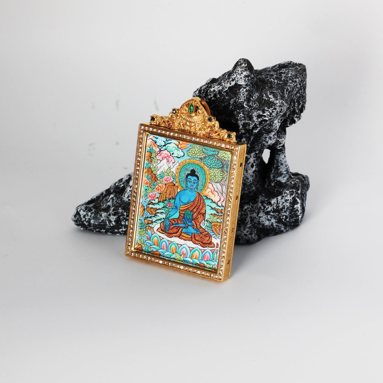 Side detail of Bhaisajyaguru Buddha mini thangka pendant highlighting the double-sided construction, metal edge finishing, and refined hand-painted thangka craftsmanship